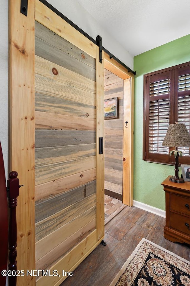 interior space featuring baseboards and hardwood / wood-style floors