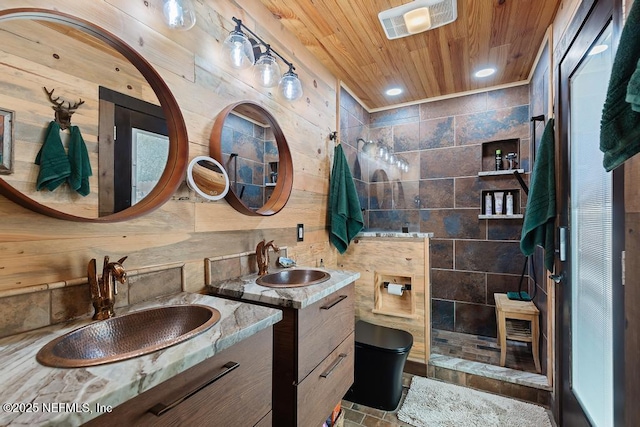 bathroom with wood ceiling, two vanities, a walk in shower, and a sink