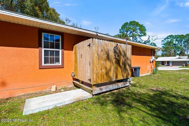 view of property exterior featuring a lawn and stucco siding