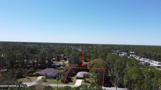 drone / aerial view featuring a view of trees