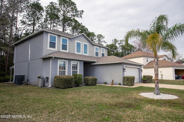 traditional-style house with a front lawn, central AC, driveway, and stucco siding