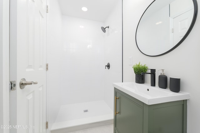 full bath with a stall shower, vanity, and recessed lighting