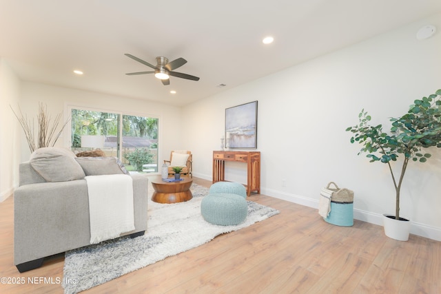 living area featuring recessed lighting, ceiling fan, baseboards, and wood finished floors