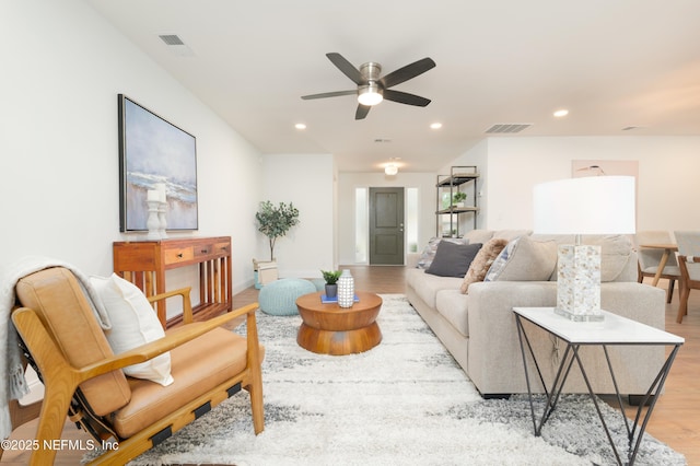 living room featuring ceiling fan, recessed lighting, visible vents, and light wood-style floors