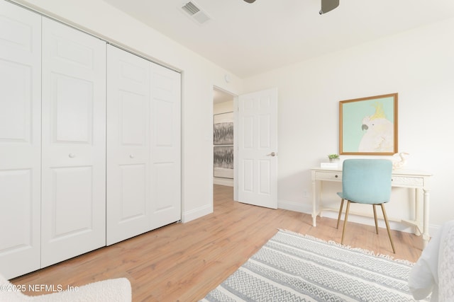 office with wood finished floors, visible vents, and baseboards