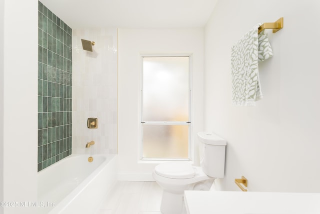 full bath featuring bathing tub / shower combination, toilet, and baseboards