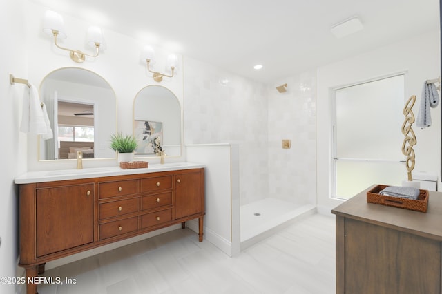 bathroom featuring a walk in shower, double vanity, and a sink