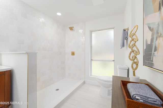 bathroom featuring toilet, recessed lighting, a walk in shower, and vanity