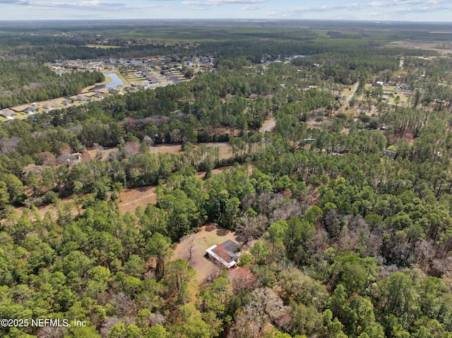 drone / aerial view with a view of trees