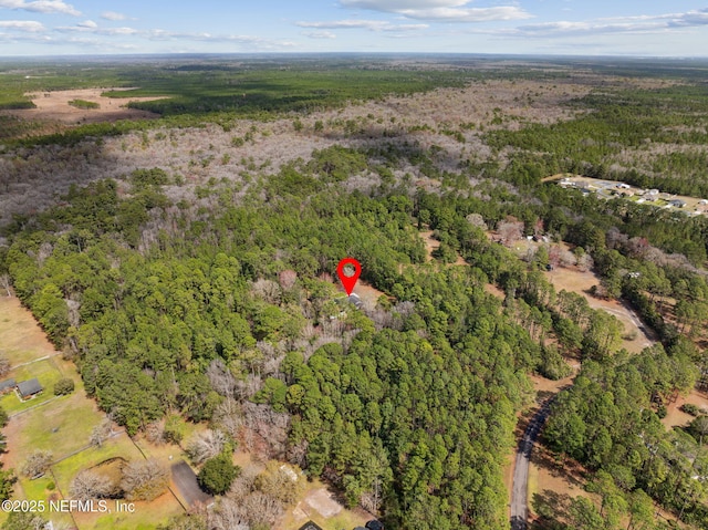 birds eye view of property with a view of trees