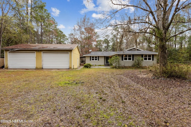 single story home with a garage and a front yard