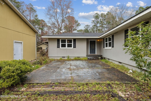 doorway to property featuring crawl space and a patio area