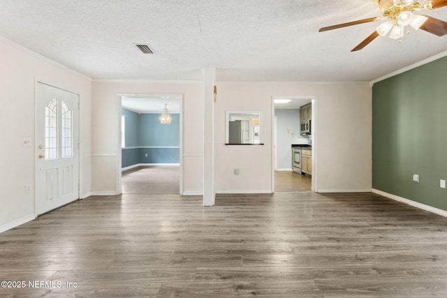 interior space with dark wood-style floors, visible vents, a textured ceiling, and ornamental molding