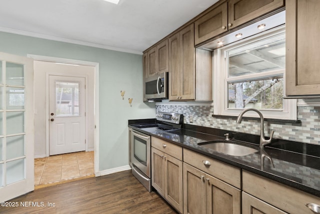 kitchen with tasteful backsplash, ornamental molding, stainless steel appliances, and dark wood-type flooring