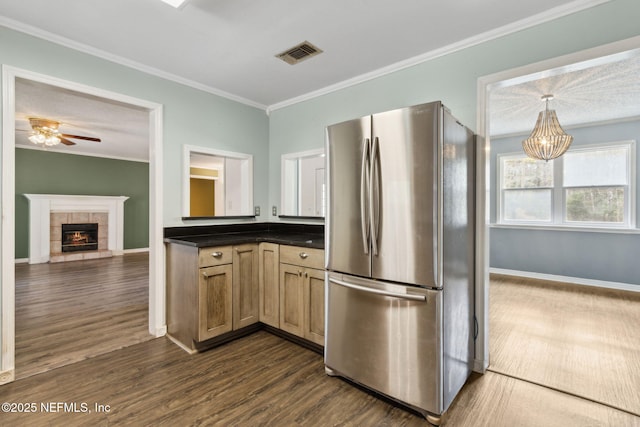 kitchen featuring visible vents, dark countertops, dark wood finished floors, and freestanding refrigerator