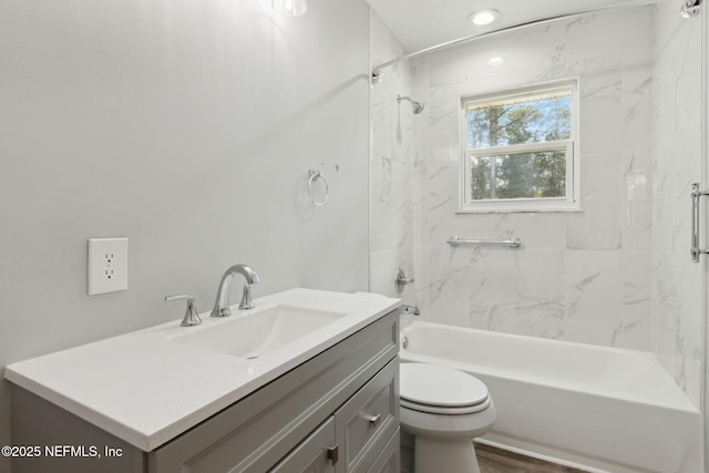 bathroom featuring vanity, bathtub / shower combination, and toilet