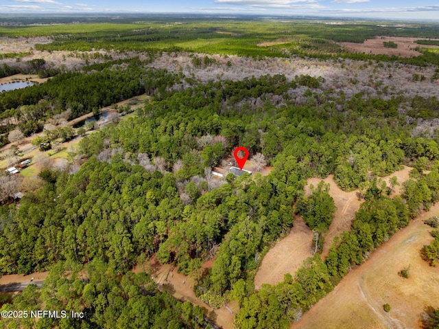 birds eye view of property featuring a view of trees