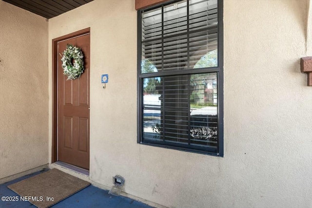 property entrance with stucco siding