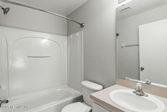 bathroom featuring visible vents, toilet, a textured ceiling, bathtub / shower combination, and vanity