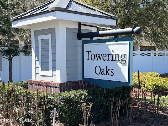 community sign featuring fence