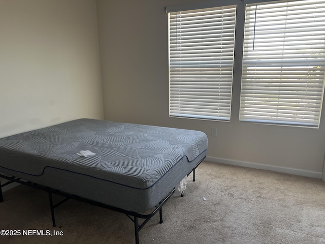 bedroom featuring carpet flooring and baseboards