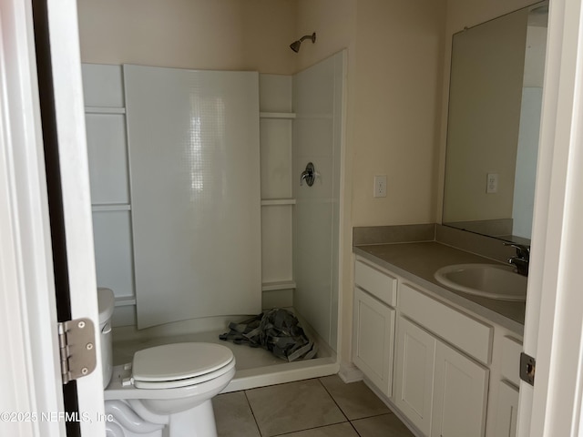 full bathroom featuring a shower, vanity, toilet, and tile patterned floors