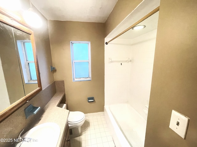 bathroom featuring tile patterned flooring, baseboards, vanity, and toilet