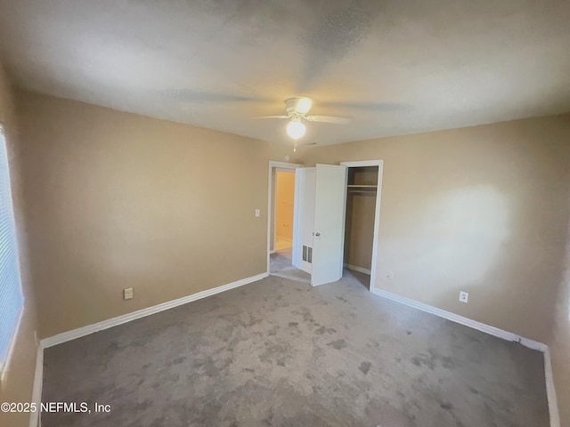 unfurnished bedroom featuring a ceiling fan, a closet, visible vents, and baseboards