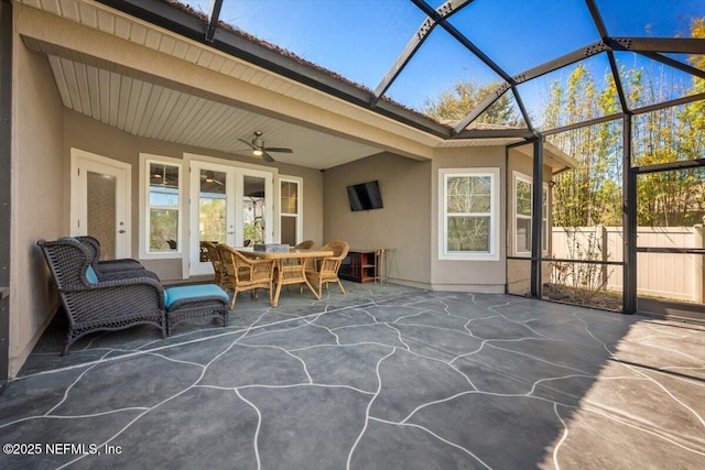 sunroom featuring beamed ceiling and ceiling fan