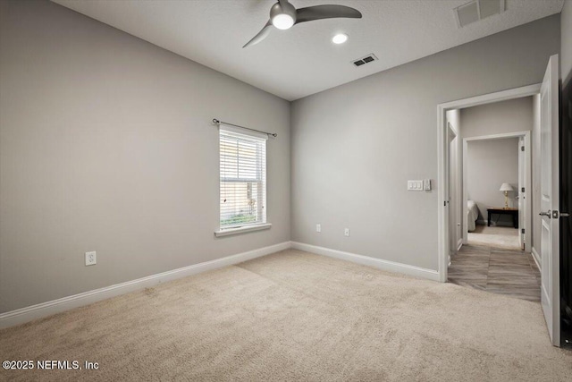 unfurnished bedroom featuring visible vents, baseboards, a ceiling fan, and carpet flooring