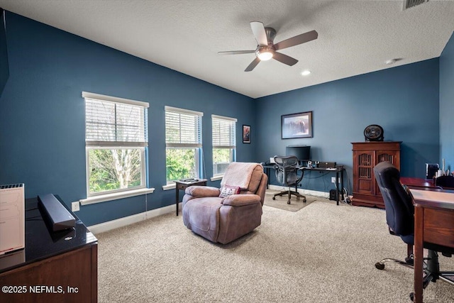 home office featuring a textured ceiling, baseboards, carpet, and a ceiling fan