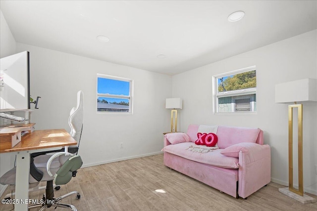 office space featuring baseboards and light wood-style flooring