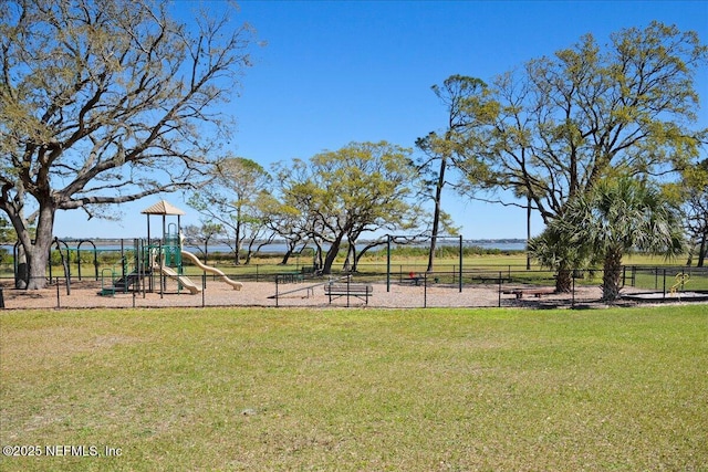 community jungle gym featuring a lawn