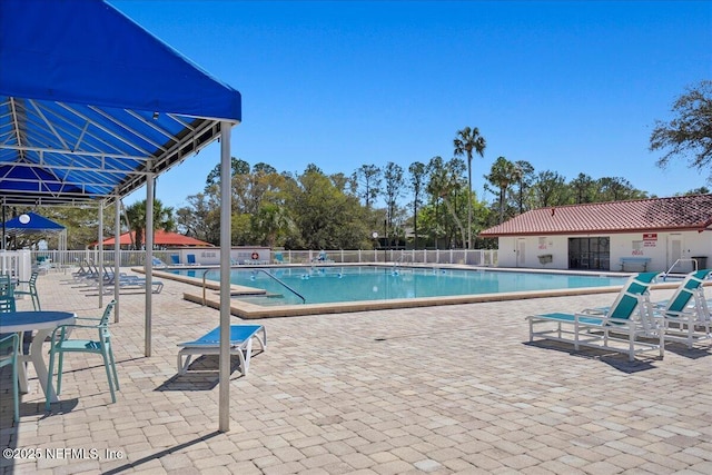 pool featuring a patio and fence