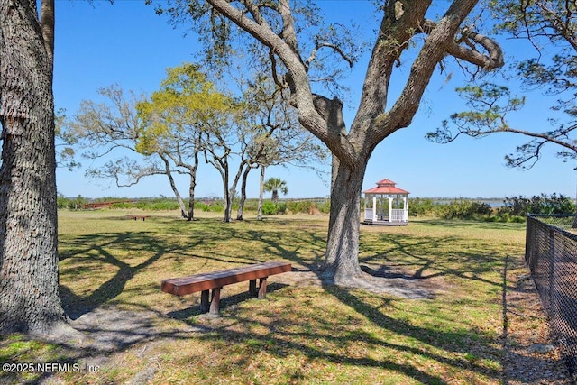 view of community with a gazebo, a yard, and fence