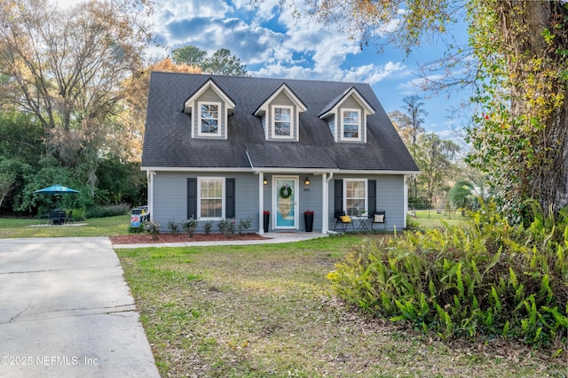 cape cod home with a front yard