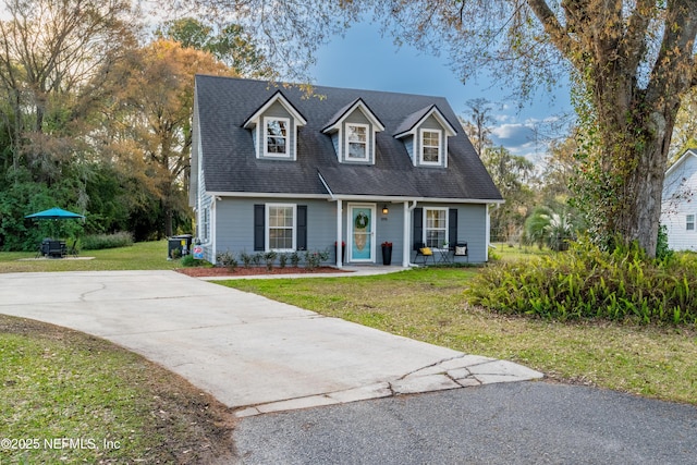 view of front of house featuring concrete driveway and a front yard