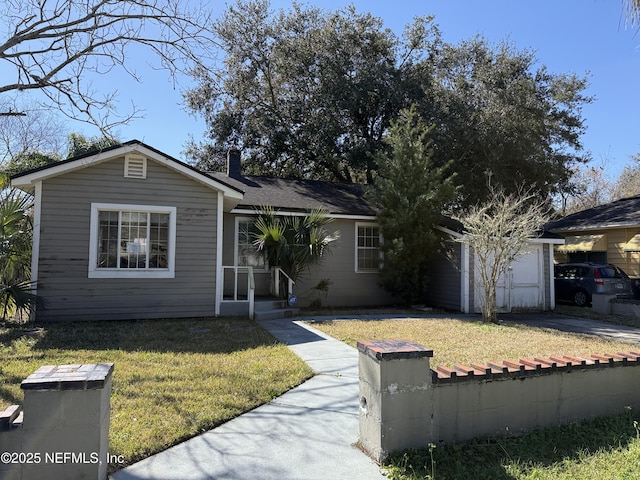 single story home with a garage, concrete driveway, a chimney, and a front lawn