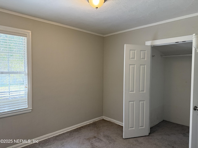 unfurnished bedroom featuring carpet, baseboards, and crown molding