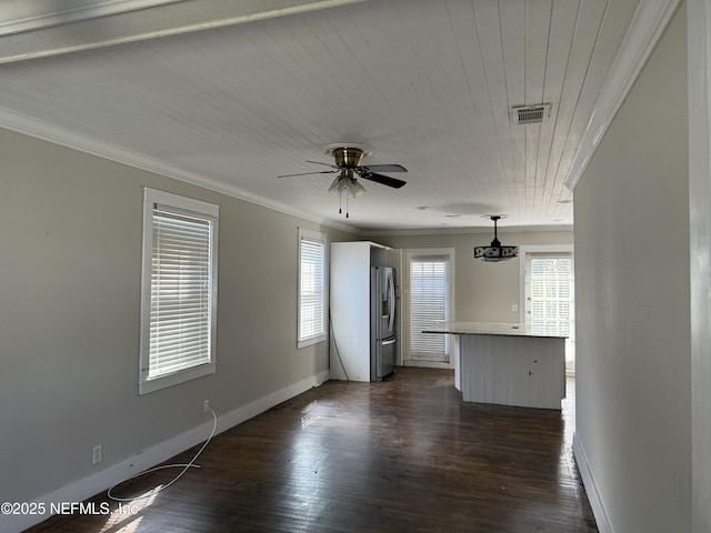 interior space featuring baseboards, visible vents, a ceiling fan, dark wood-style flooring, and crown molding