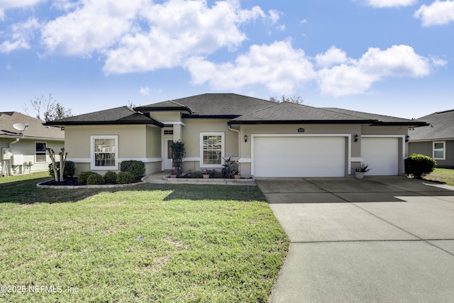 prairie-style home featuring roof with shingles, stucco siding, concrete driveway, a garage, and a front lawn