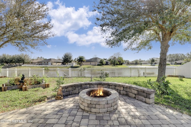 view of patio / terrace featuring a residential view, a fenced backyard, and a fire pit