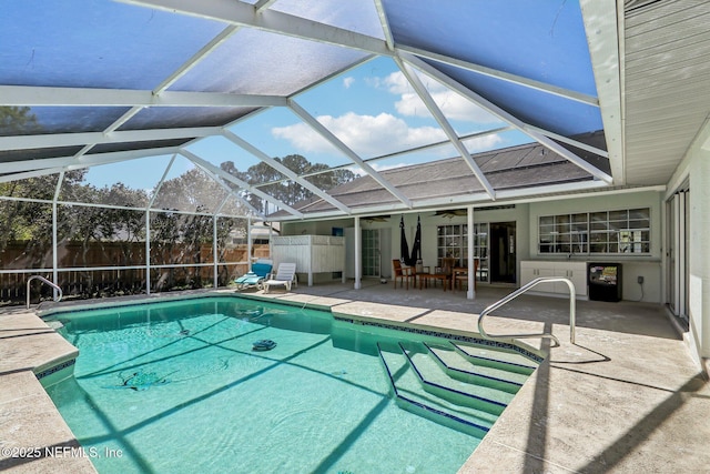 view of pool featuring a patio, glass enclosure, fence private yard, and a fenced in pool