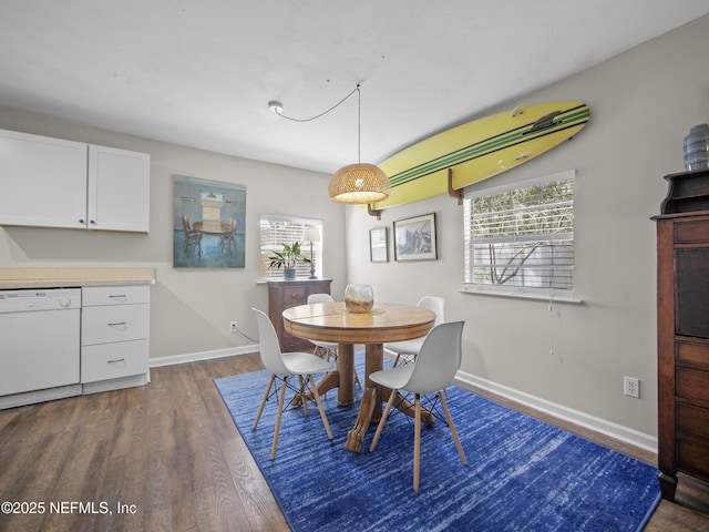 dining room featuring dark wood-style floors and baseboards