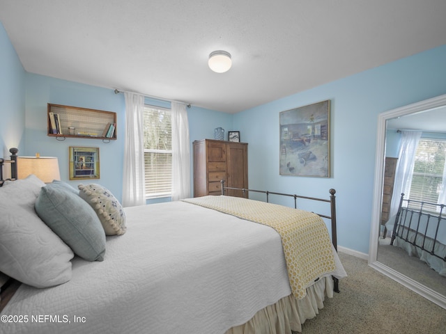 carpeted bedroom with baseboards