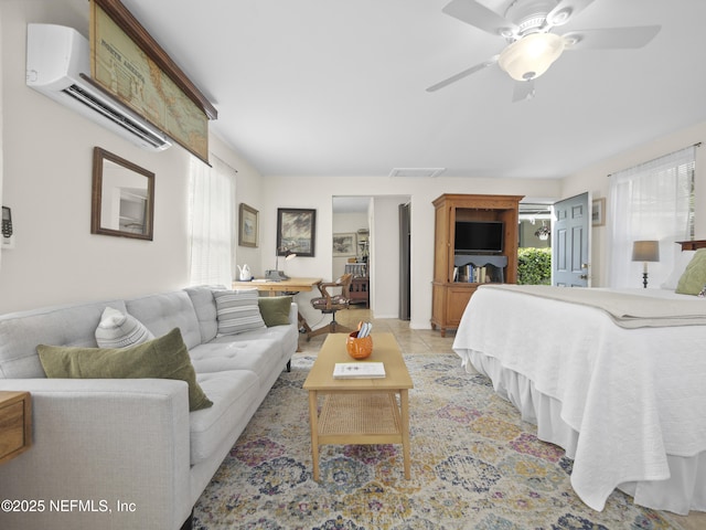 bedroom featuring light tile patterned floors, a ceiling fan, visible vents, and a wall mounted AC