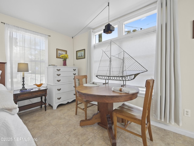 dining area featuring lofted ceiling