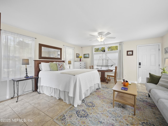 bedroom featuring baseboards, a ceiling fan, and light tile patterned flooring