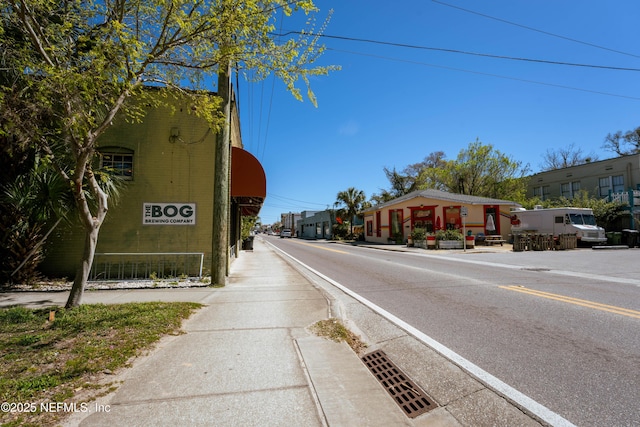 view of road with sidewalks and curbs