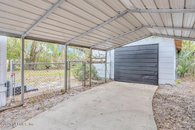 exterior space featuring a carport, fence, and a gate